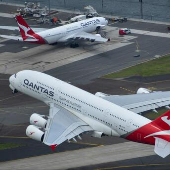 Qantas aircraft on the runway and in flight