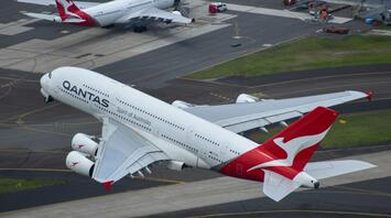 Qantas aircraft on the runway and in flight