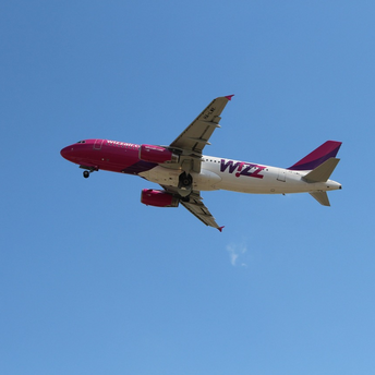 Wizz Air aircraft in flight against clear sky