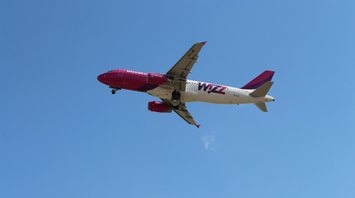 Wizz Air aircraft in flight against clear sky