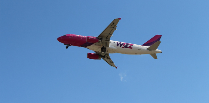 Wizz Air aircraft in flight against clear sky