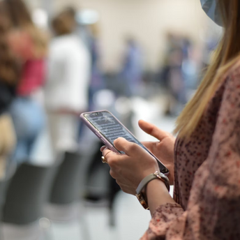 Passenger checking flight details on phone