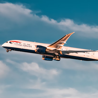 British Airways airplane in flight against blue sky