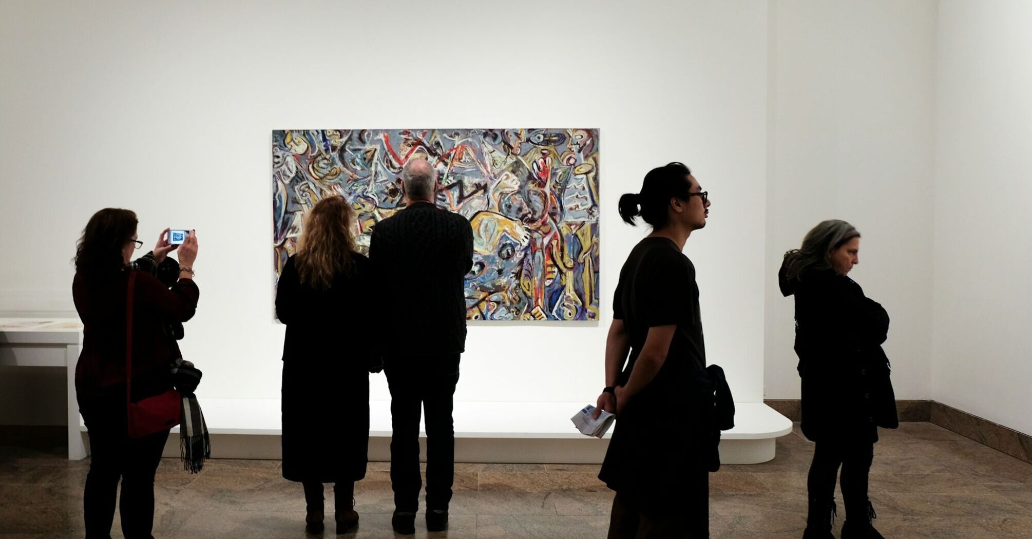 Visitors viewing artwork in a museum