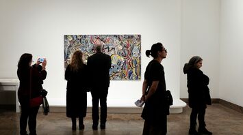 Visitors viewing artwork in a museum