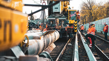 Rail workers installing new tracks during maintenance