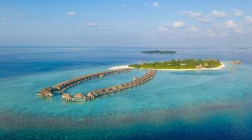 Overwater villas and tropical island in the Maldives