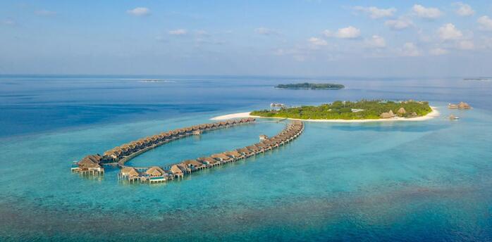 Overwater villas and tropical island in the Maldives