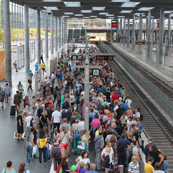 Crowds of passengers waiting at a busy train platform