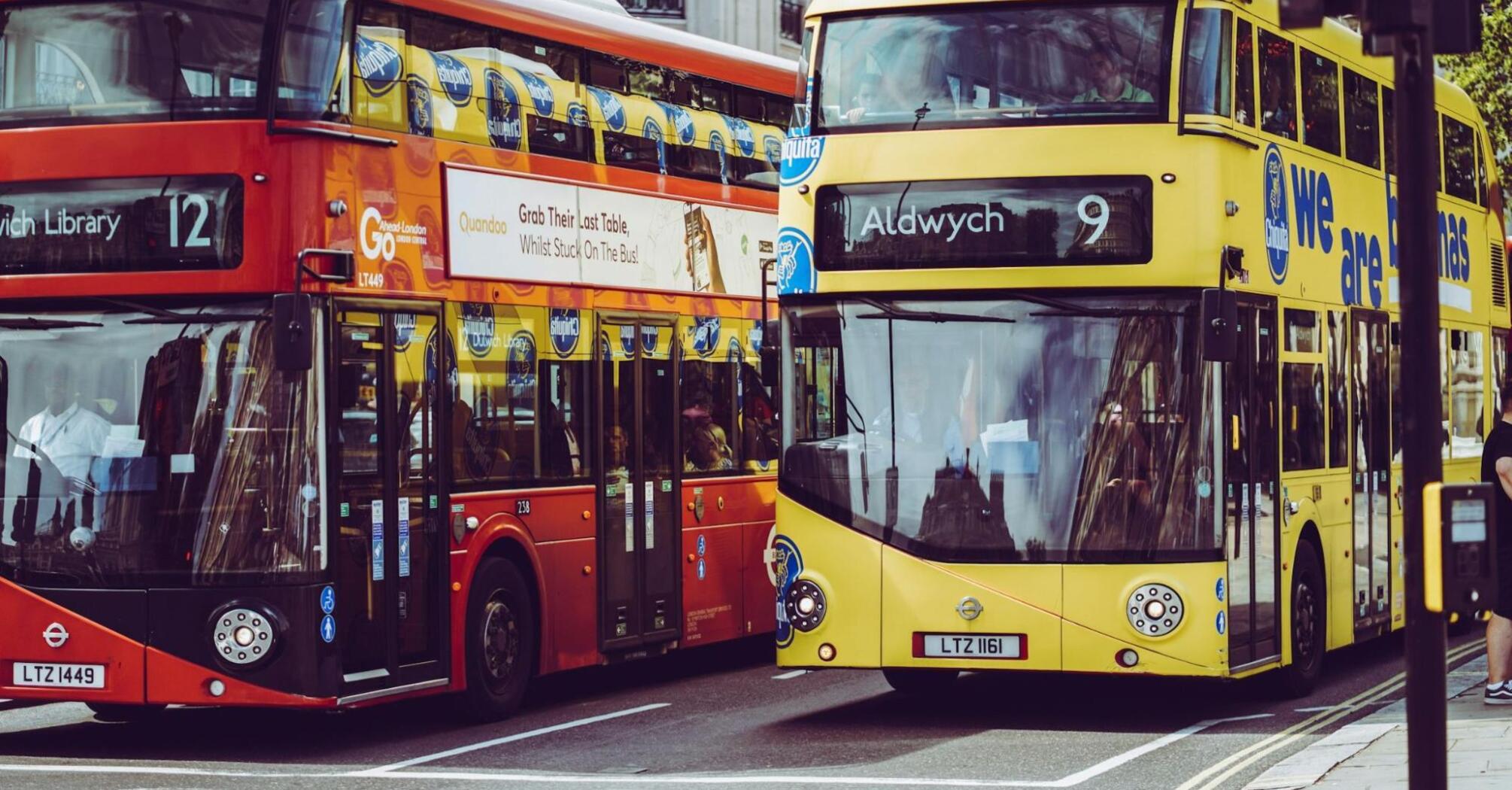 Two double-decker buses on a city street in the UK