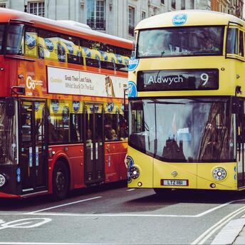 Two double-decker buses on a city street in the UK