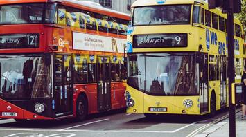 Two double-decker buses on a city street in the UK