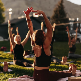 Group of people practicing outdoor yoga during a wellness retreat