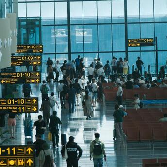 Passengers waiting at airport terminal gates