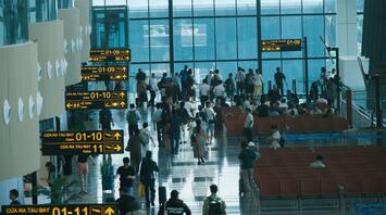 Passengers waiting at airport terminal gates
