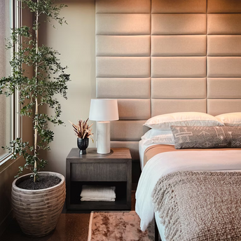 Modern hotel room with soft lighting, cozy bed, and minimal design