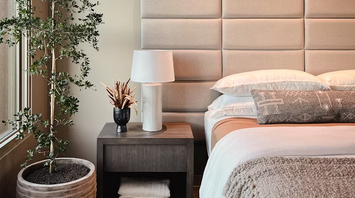 Modern hotel room with soft lighting, cozy bed, and minimal design