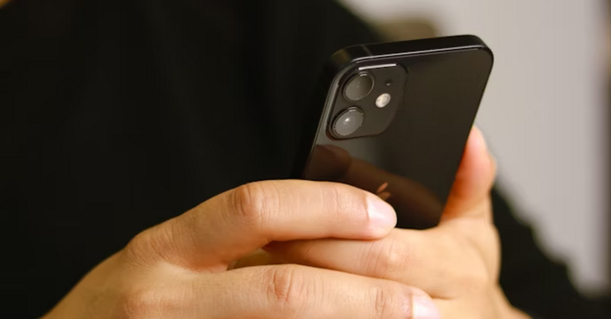 Man using smartphone with focus on screen