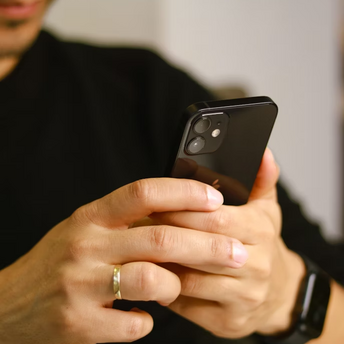 Man using smartphone with focus on screen