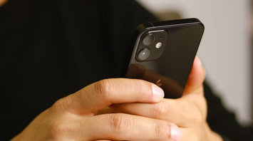 Man using smartphone with focus on screen