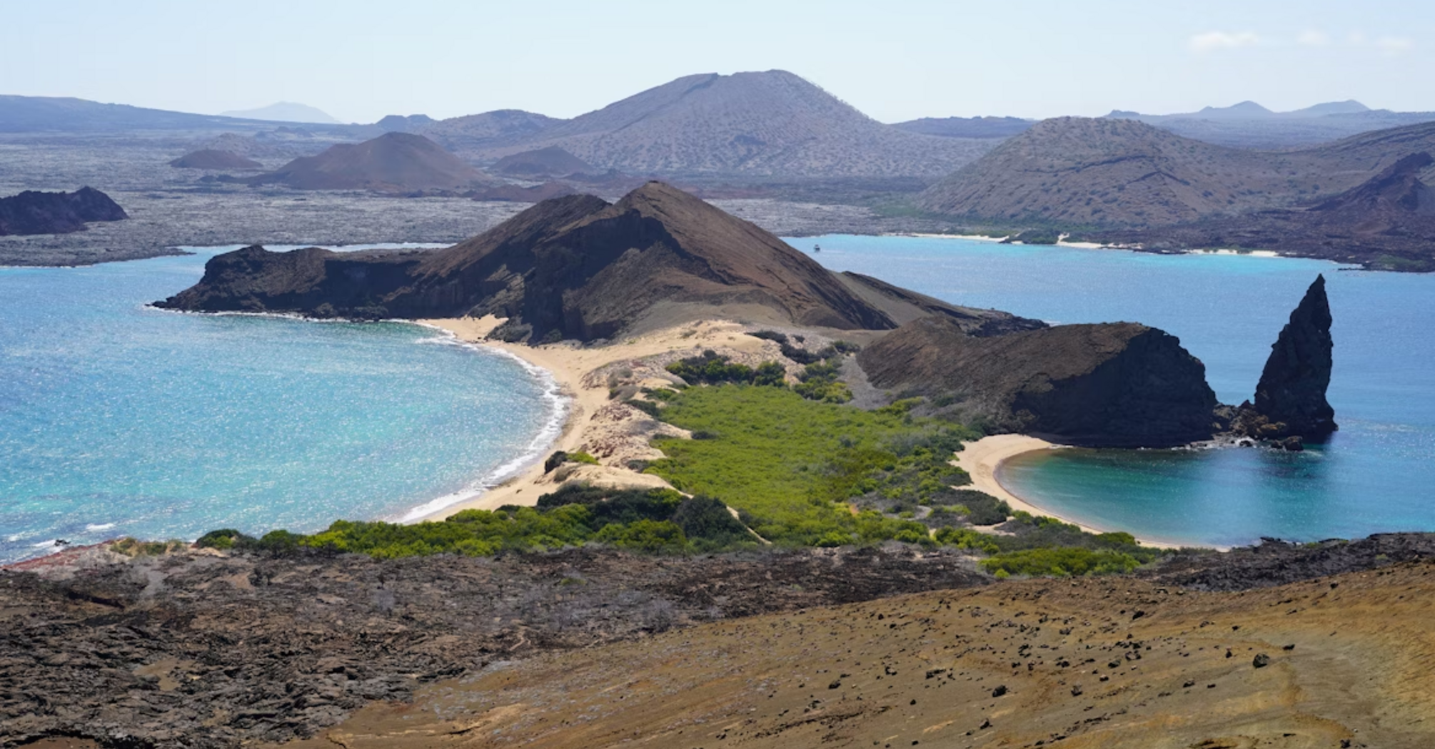 Aerial view of a volcanic coastline and beaches in the Galápagos Islands
