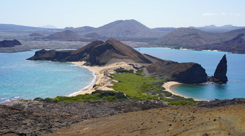Aerial view of a volcanic coastline and beaches in the Galápagos Islands