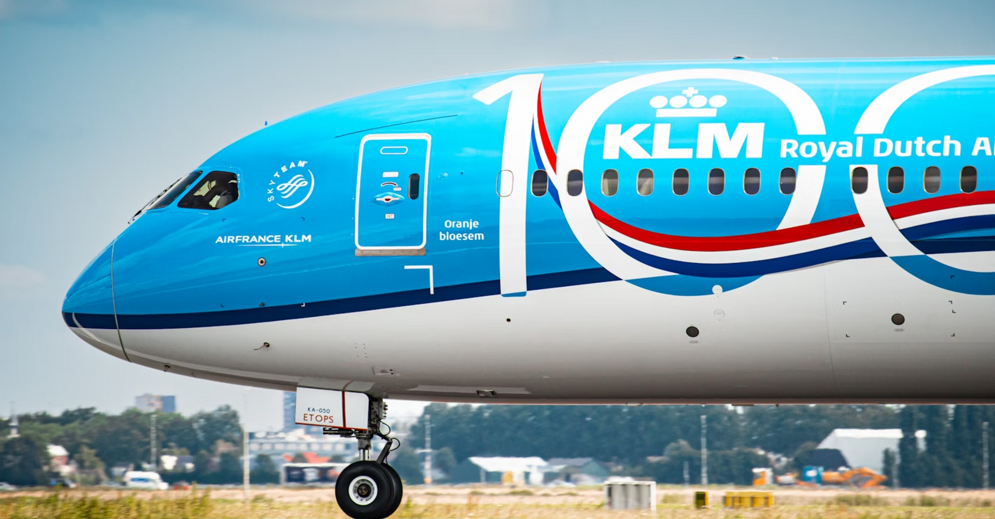 Close-up of a KLM aircraft nose with 100th anniversary livery at an airport