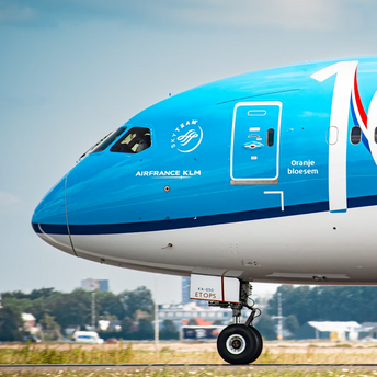 Close-up of a KLM aircraft nose with 100th anniversary livery at an airport