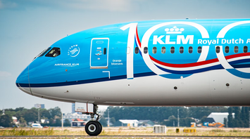 Close-up of a KLM aircraft nose with 100th anniversary livery at an airport