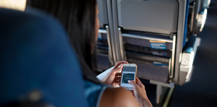 A passenger using a smartphone during a flight