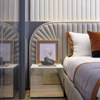 Modern hotel bedroom interior with neutral tones and accent pillows