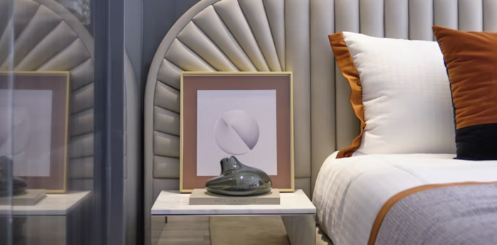 Modern hotel bedroom interior with neutral tones and accent pillows