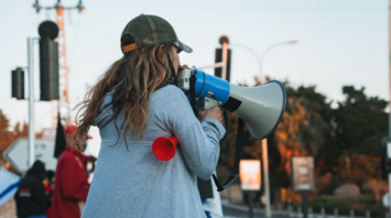 Person using megaphone during a street protest