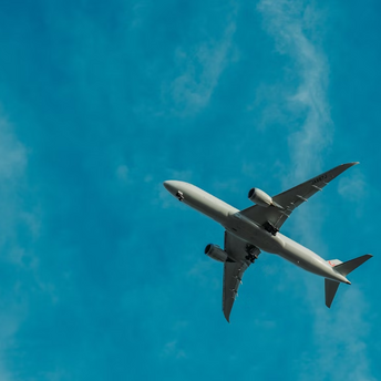 Airplane flying against blue sky