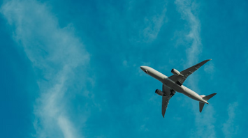 Airplane flying against blue sky