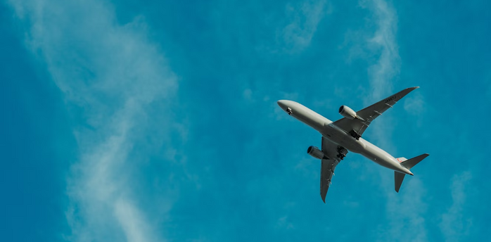 Airplane flying against blue sky
