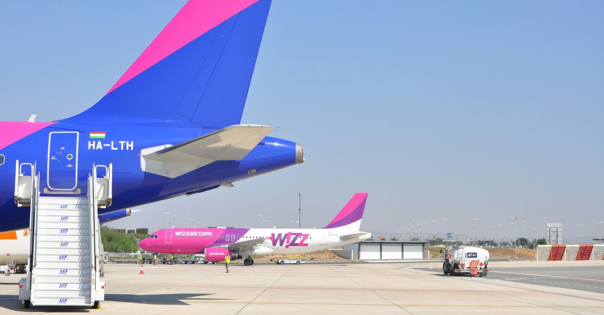 Close-up of Wizz Air aircraft tails on airport apron