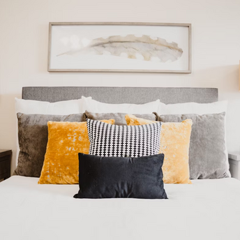 Modern bedroom with decorative pillows and lamps