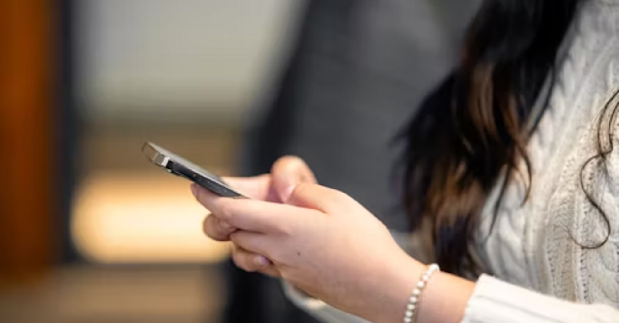 Woman checking phone for updates