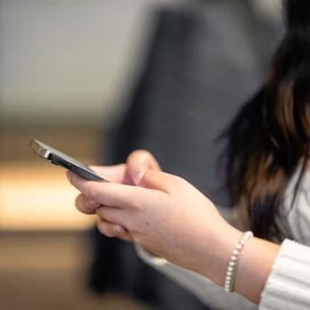 Woman checking phone for updates