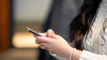 Woman checking phone for updates