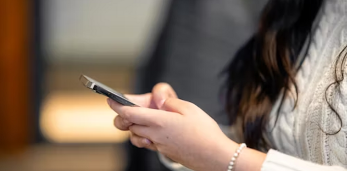 Woman checking phone for updates