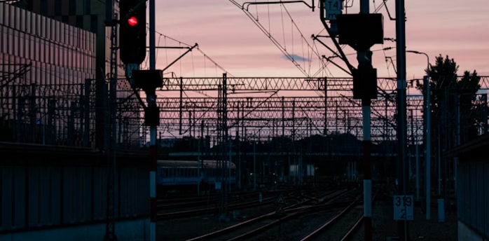 Railway signals glowing red at sunset