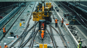 Workers repairing railway tracks during maintenance