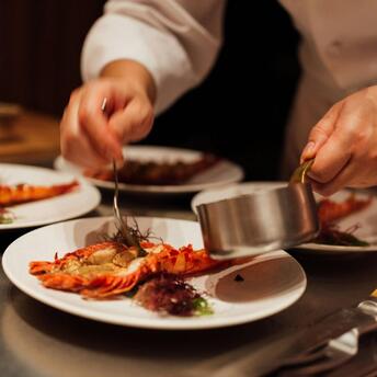 Chef plating gourmet seafood dish