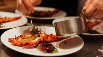 Chef plating gourmet seafood dish
