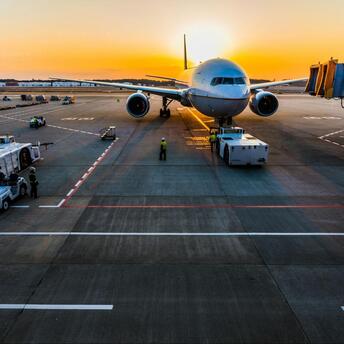 Airplane preparing for departure at sunrise