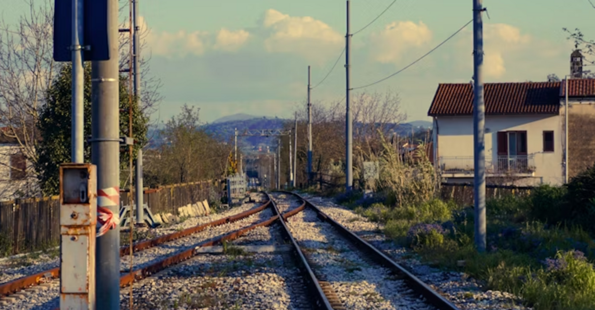 Railway signal light along rural tracks