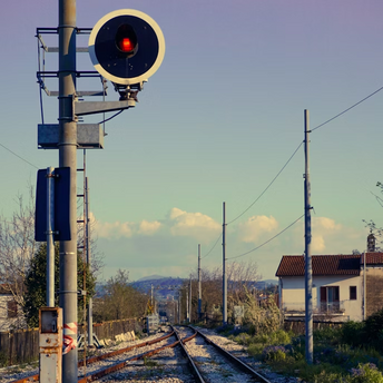 Railway signal light along rural tracks
