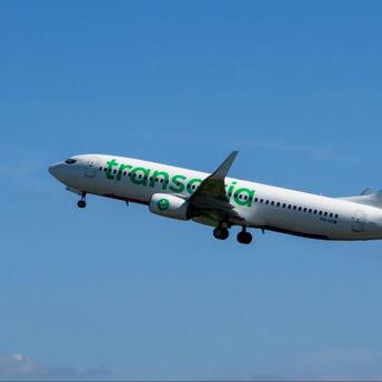 Transavia aircraft taking off against clear blue sky